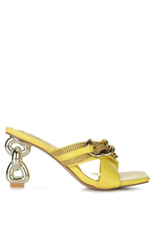 Give your look a unique touch of creativity with these stylish metallic chain-heeled sandals. The golden chain strap and head-turning diamante detail will give any outfit the right amount of edge and glamour. Chic, unique, and full of style. Avah Couture