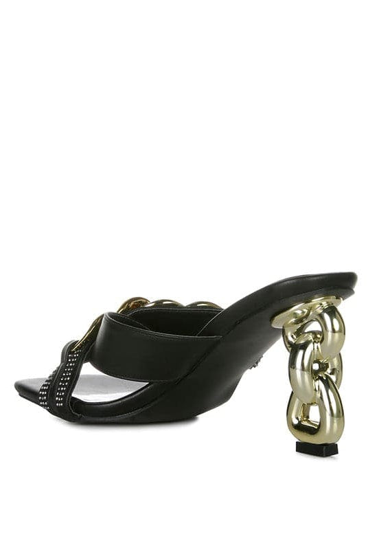 Give your look a unique touch of creativity with these stylish metallic chain-heeled sandals. The golden chain strap and head-turning diamante detail will give any outfit the right amount of edge and glamour. Chic, unique, and full of style. Avah Couture