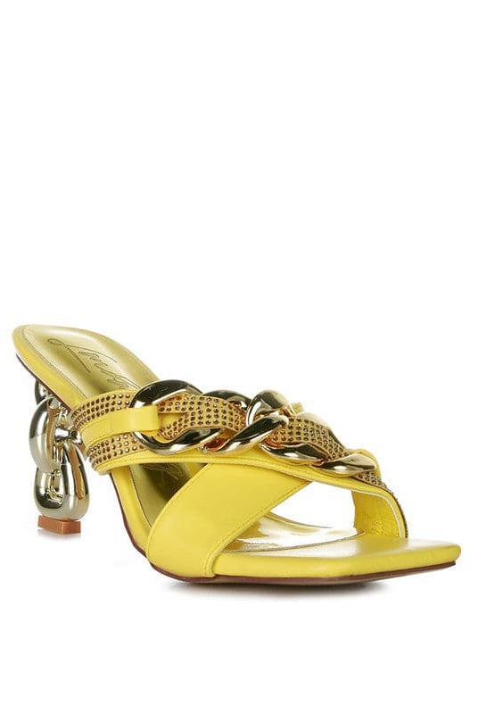 Give your look a unique touch of creativity with these stylish metallic chain-heeled sandals. The golden chain strap and head-turning diamante detail will give any outfit the right amount of edge and glamour. Chic, unique, and full of style. Avah Couture