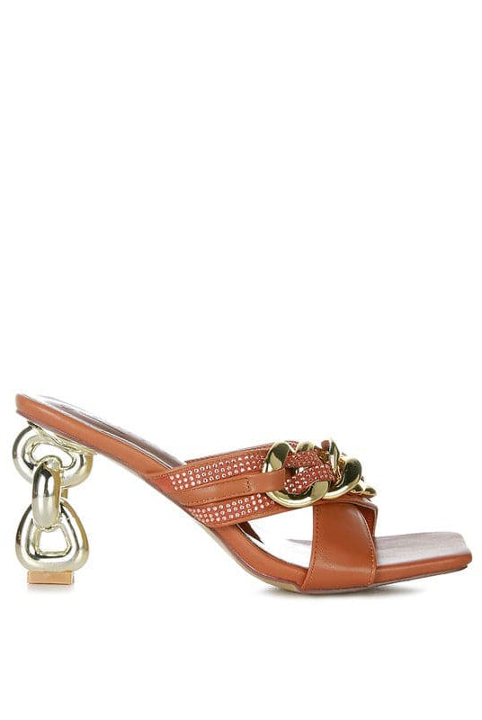 Give your look a unique touch of creativity with these stylish metallic chain-heeled sandals. The golden chain strap and head-turning diamante detail will give any outfit the right amount of edge and glamour. Chic, unique, and full of style. Avah Couture