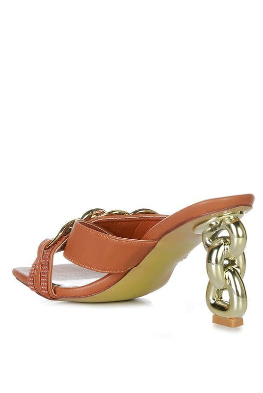 Give your look a unique touch of creativity with these stylish metallic chain-heeled sandals. The golden chain strap and head-turning diamante detail will give any outfit the right amount of edge and glamour. Chic, unique, and full of style. Avah Couture