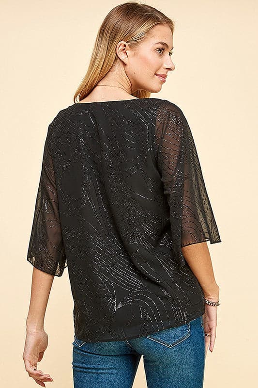 Holiday sparkle! This blouse is perfect for any occasion. All you need is a new pair of strappy sandals and your favorite trousers or jeans and you’re ready to go. Features glittered print, tulip sleeves and full lining. Avah Couture