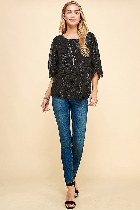 Holiday sparkle! This blouse is perfect for any occasion. All you need is a new pair of strappy sandals and your favorite trousers or jeans and you’re ready to go. Features glittered print, tulip sleeves and full lining. Avah Couture