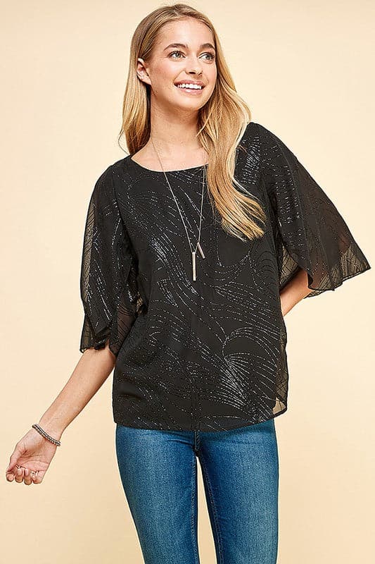 Holiday sparkle! This blouse is perfect for any occasion. All you need is a new pair of strappy sandals and your favorite trousers or jeans and you’re ready to go. Features glittered print, tulip sleeves and full lining. Avah Couture