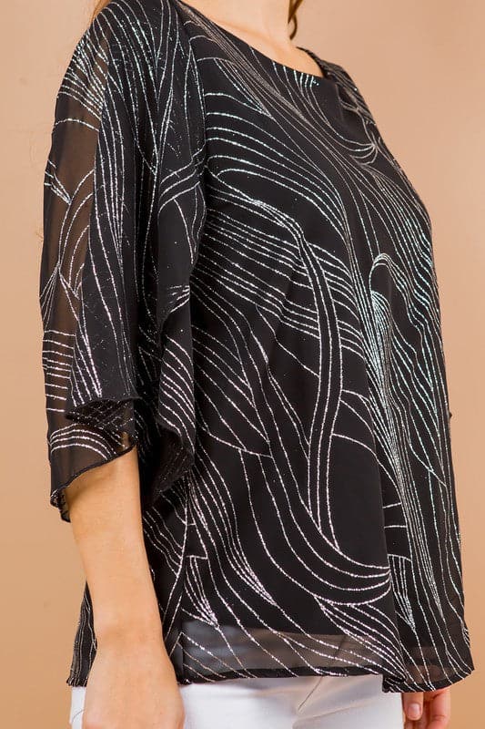 Holiday sparkle! This blouse is perfect for any occasion. All you need is a new pair of strappy sandals and your favorite trousers or jeans and you’re ready to go. Features glittered print, tulip sleeves and full lining. Avah Couture
