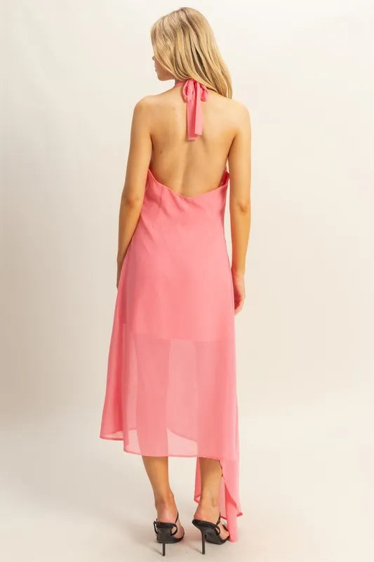 Back view of pink chiffon halter midi dress with open back, tie neck and asymmetrical hem
