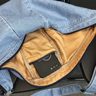 Denim sling bag interior with zip pocket and double zipper closure
