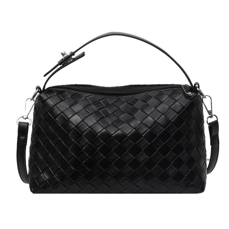 Black woven handbag on a white background