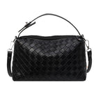 Black woven handbag on a white background