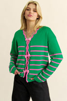 Green and pink striped bow-front cardigan worn on model, front view
