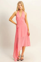 Pink chiffon asymmetrical midi dress with halter neckline, rosette detail and draped side hem
