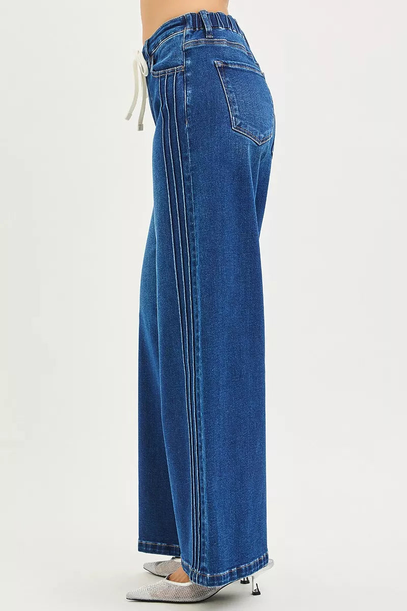 Side view of blue wide leg jeans showing raised seam detail and full length, AVAH