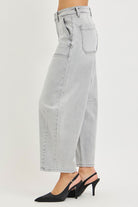 Side view of grey curved barrel leg crop jeans showing silhouette and ankle length, AVAH