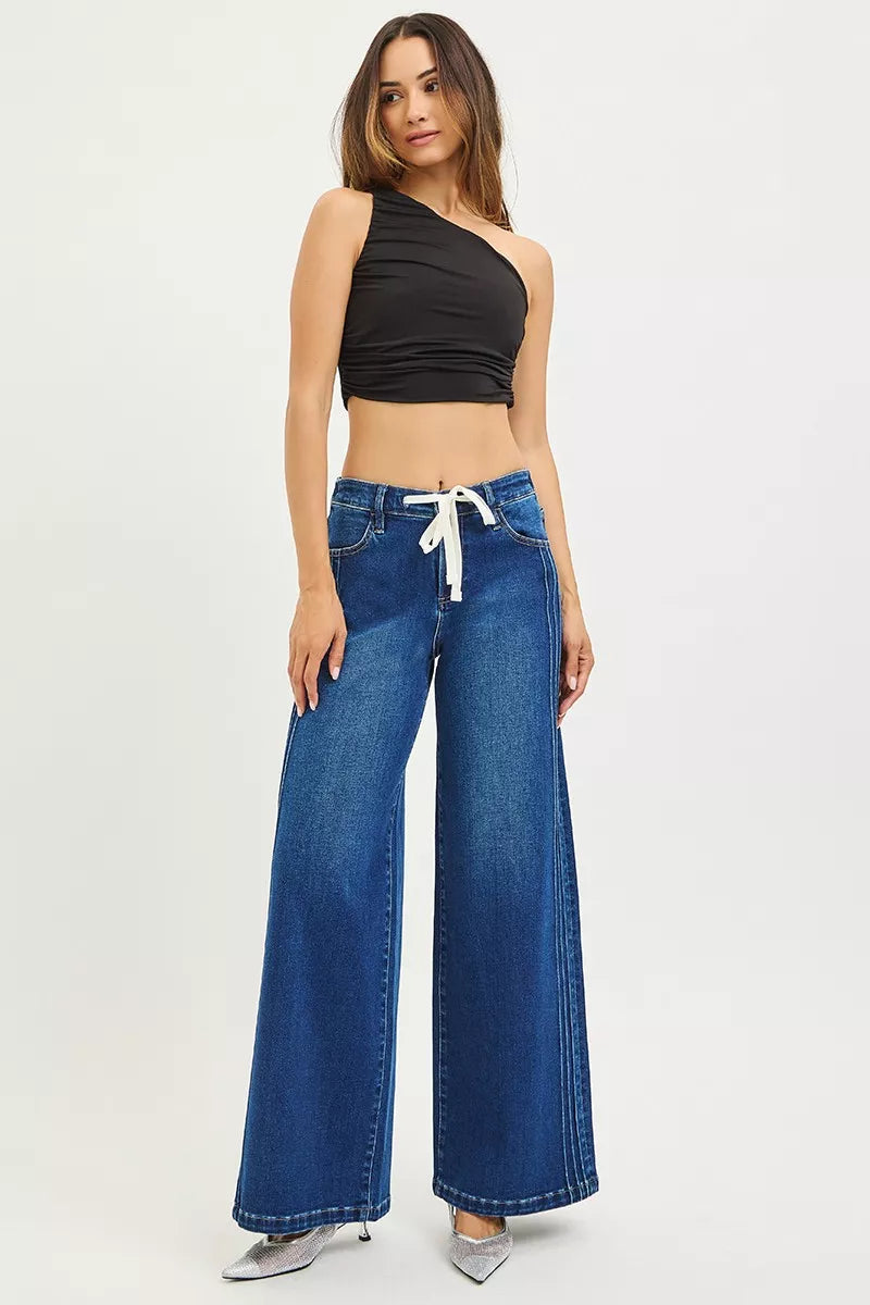  Deep indigo wide leg drawstring jeans styled with black crop top and silver heels, AVAH