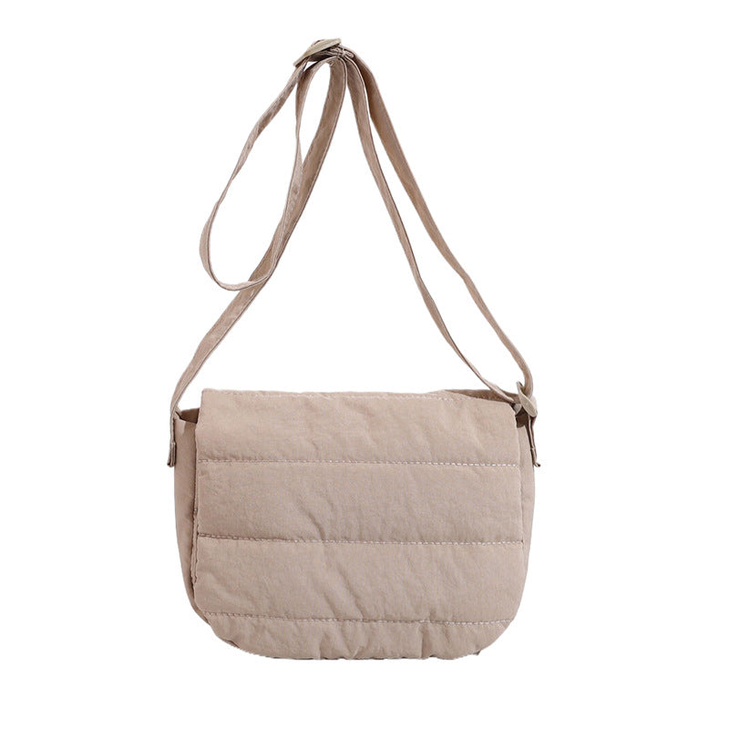 Beige quilted shoulder bag on a white background