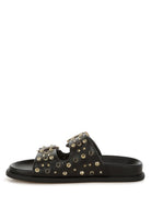 Side view of black faux leather slide sandal with gold and black studded embellishments