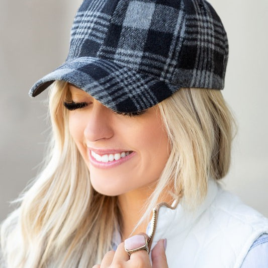Front angle of black plaid knit flannel baseball hat with curved brim.