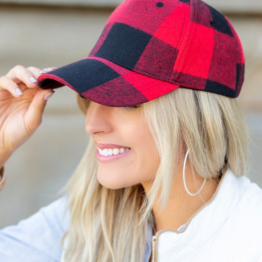 Side view of red buffalo plaid hat showing low-profile structured crown and adjustable closure.