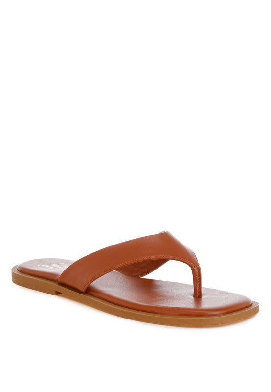 Tan minimal faux leather thong sandals with cushioned comfort and a sleek square toe. 