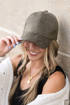 Model wearing olive vegan suede baseball cap, front view-AVAH