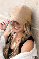 Front view of khaki cap showcasing brim 
