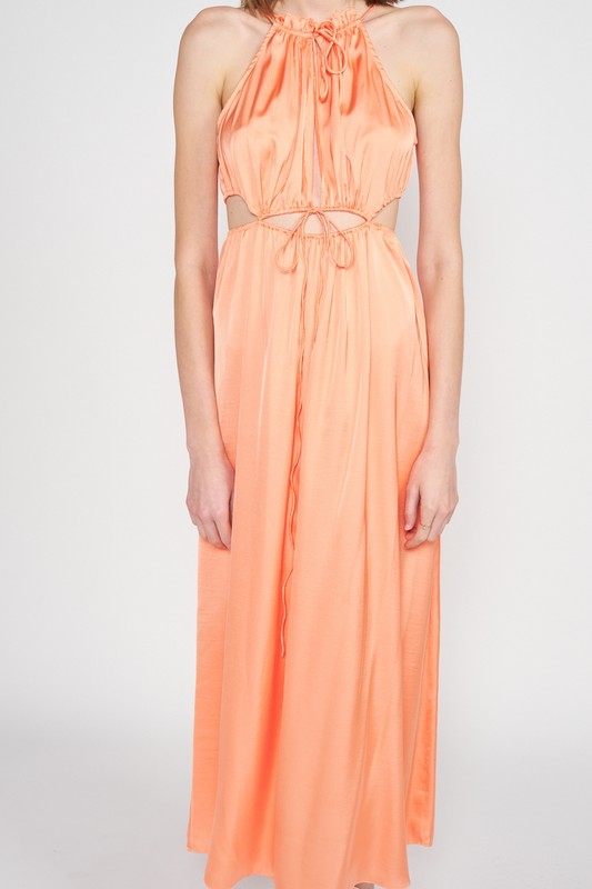 Close-up of gathered halter neck and waist tie detail on peach satin midi dress