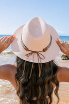 Back view of blush straw hat with suede tie detail
