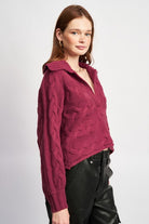 Burgundy cable-knit sweater with oversized collar and relaxed fit, angled view.