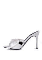 Side view of white satin bow stiletto mule with rhinestone strap