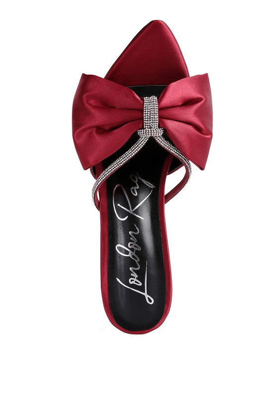 Top view of burgundy satin heel showing oversized bow and rhinestone center