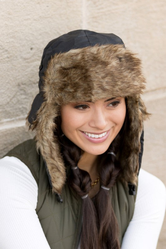 Black faux fur winter aviator hat with quilted interior, front view
