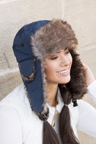 Navy faux fur aviator style winter hat with plush lining, angled profile
