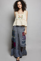 Charcoal patchwork maxi skirt with tonal embroidery, textured ruffle trim, and elastic waistband.