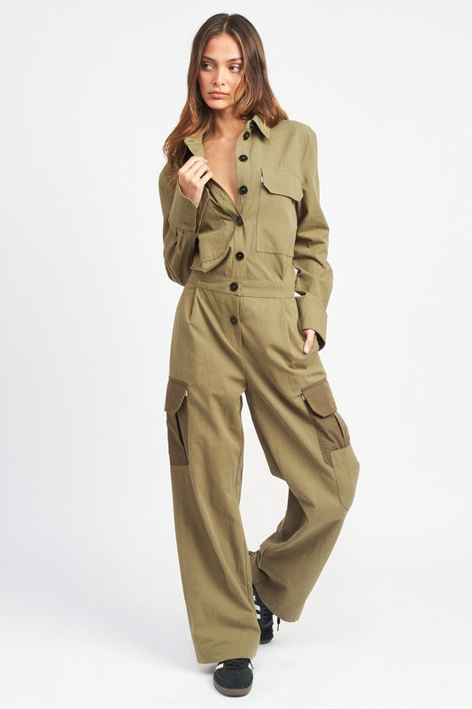 Full front view of model wearing olive green utility jumpsuit with wide legs and button-down front.-AVAH