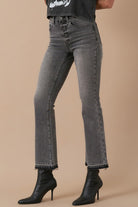 Close-up of grey denim with button fly and released hem detail- side view