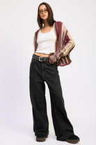 Burgundy striped cardigan styled with white tank top, black denim and belt 
