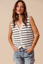 Woman wearing cream and black striped knit vest with crochet trim

