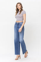 Angled side view of model in 90’s inspired relaxed fit denim with light fading
