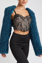 Close up of plush textured cropped shrug draped over shoulders
