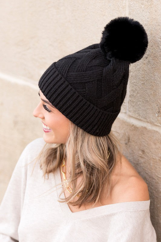 Black textured knit pom winter hat, side angle
