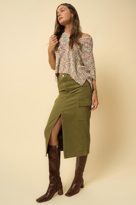 Side angle of olive cargo midi skirt featuring front slit detail.
