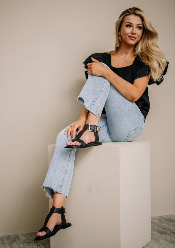 AVAH-Woman in black buckle strap sandals with square footbed and gold hardware