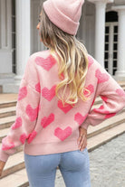 Back view of pink heart textured knit sweater showing full heart pattern