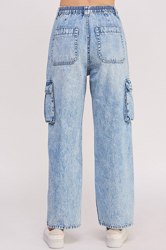 Back view of light blue denim cargo pants on a white background