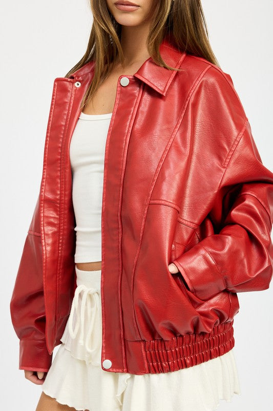 Close-up of red faux leather jacket with snap-button front and collar