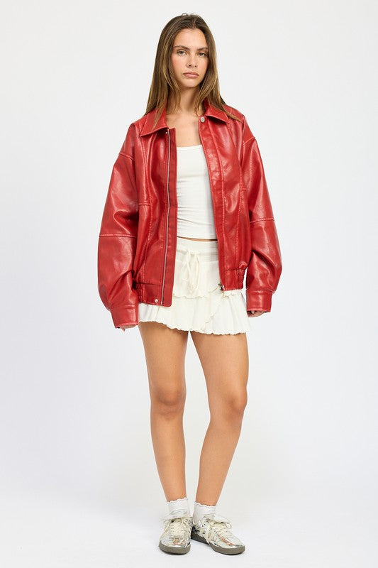 Relaxed-fit red faux leather jacket worn open over neutral layers