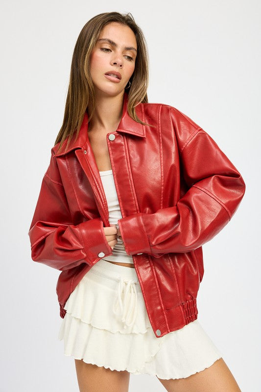 Red faux leather oversized jacket styled with white mini skirt, front view