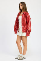 Side view of red faux leather jacket with elastic hem detail