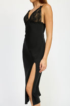 Close-up of black satin midi dress showing lace V-neckline and delicate lace trim.