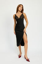 Model wearing a black satin slip midi dress with lace V-neckline and side slit.
